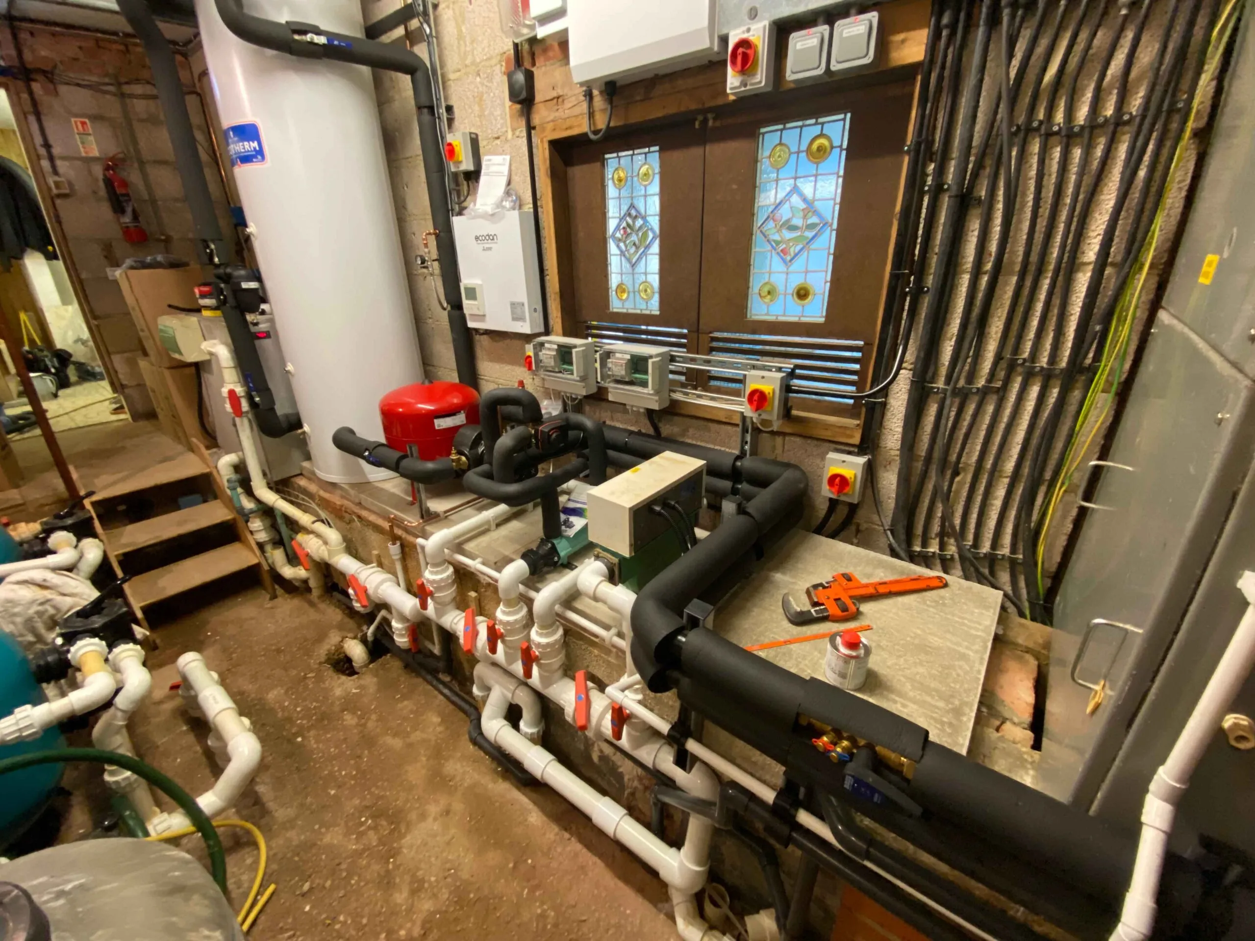 A room filled with pipes and a window.