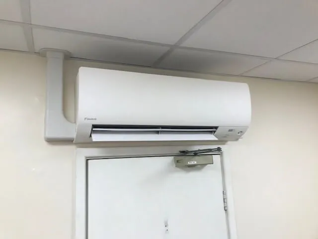 A white air conditioner mounted on a wall.