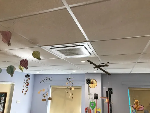 A room filled with lots of balloons and a ceiling fan.