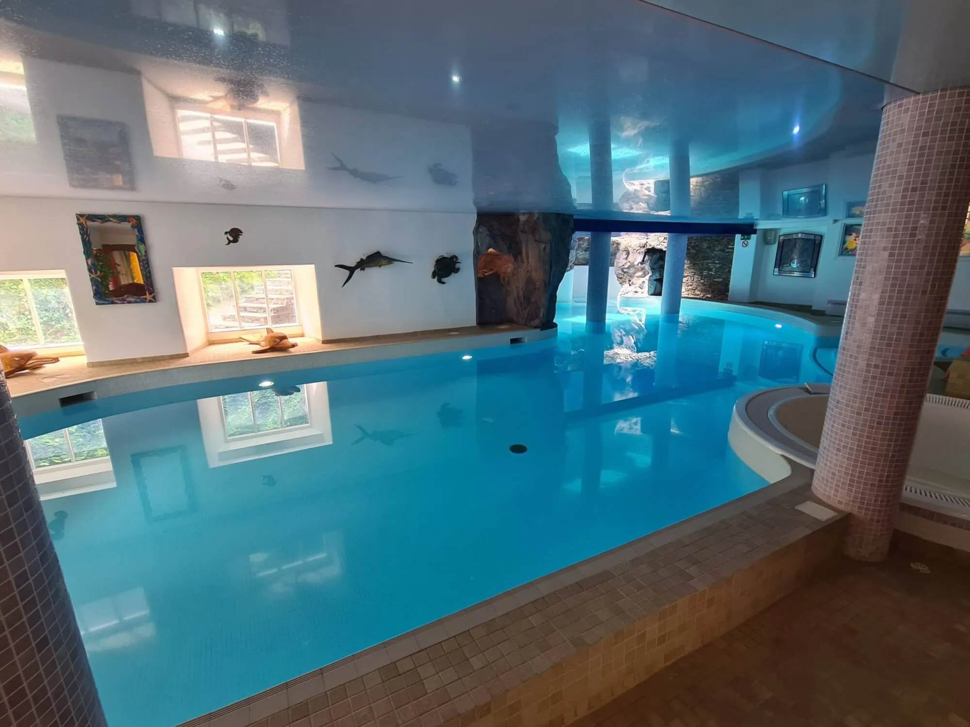 A large indoor swimming pool in a home.