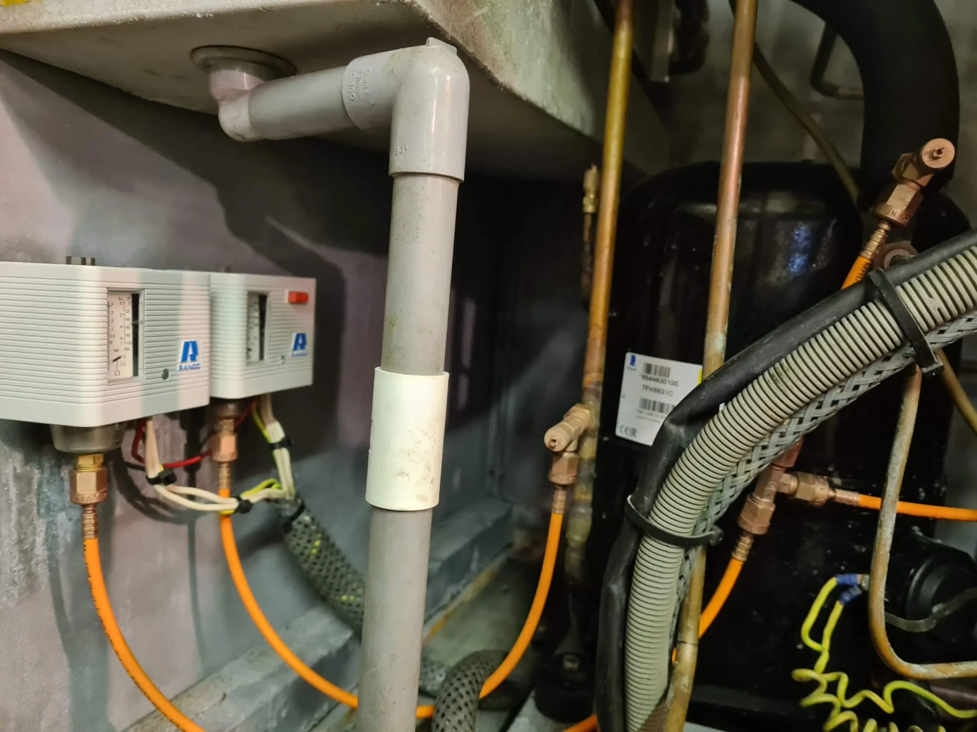 A close up of a water heater and pipes.